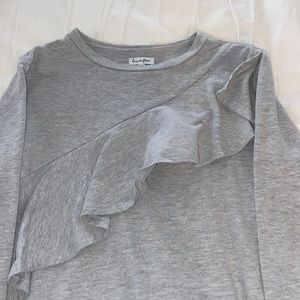 gray dress with ruffles across the front